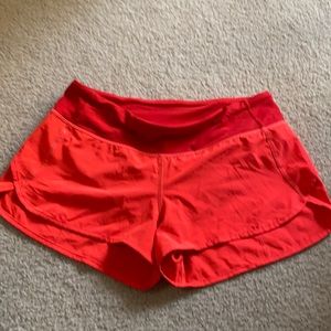 Coral orange lululemon speed shorts.